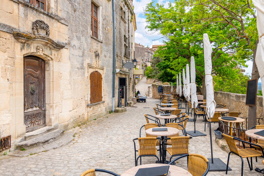 An outdoor cafe overlooking the Alpilles mountains and the valley of Les Baux in the medieval old town of Les Baux-de-Provence, in the Provence region of Southern France.	