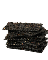 Crackers made of black sesame seeds on a white background