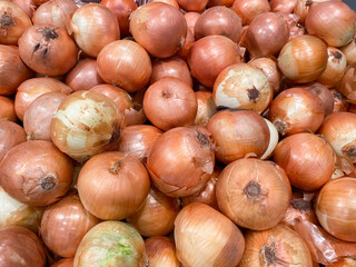 Yellow onions crop. Close up. Yellow Onion Heap on Market Stall For Sale. Fresh organic vegetables close up.
