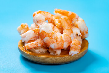 angle view fresh cooked shrimps on blue background