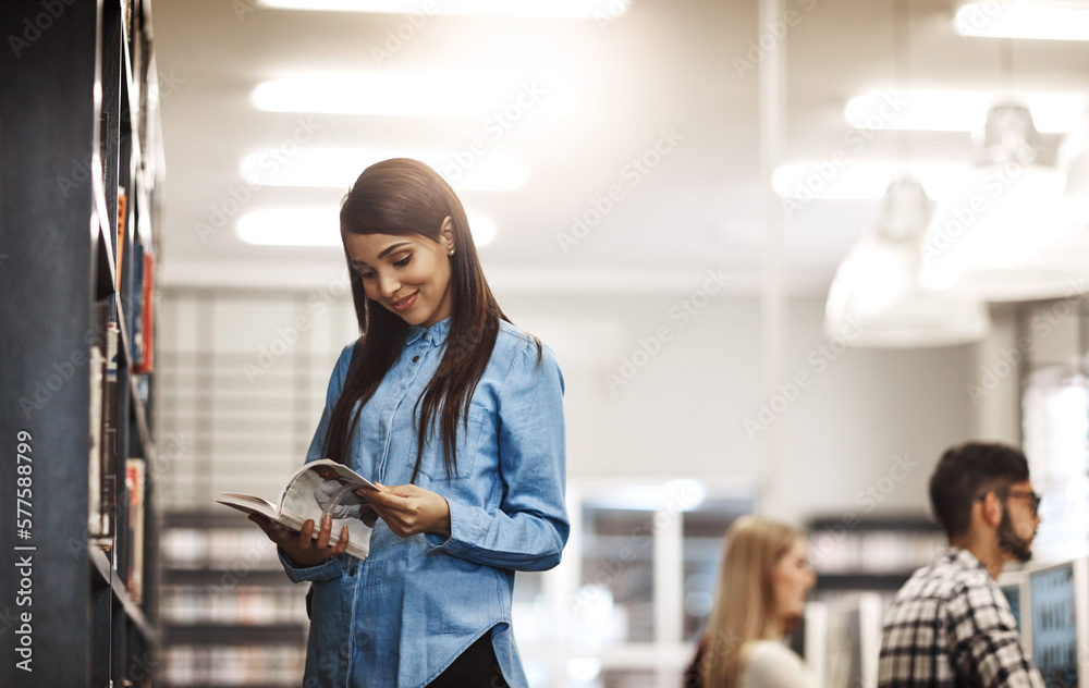 Leinwandbilder this book might help with my research. shot of a university student reading a book in the library at
