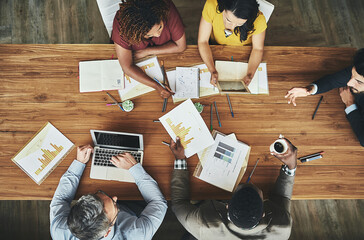 Birds-eye view of business. High angle shot of a team of businesspeople meeting around the...