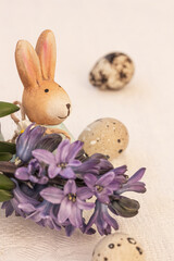Blue hyacinth flowers, eggs and ceramic rabbits. Floral Easter background, copy space