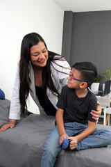 7-year-old Latino boy with glasses patient in the office of a pediatric specialist doctor there is confidence, security, tranquility and well-being