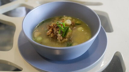 Oxtail soup is a soup made with beef tails served in a table