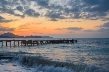Wooden pier in sea at sunrise. Koktebel. Crimea