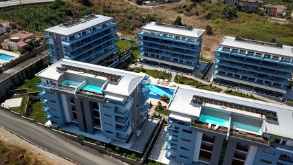 Aerial view of the hotel complex with swimming pools outdoors. Clip. Flying above recreation and spa hotel surrounded by green forest. © Media Whale Stock