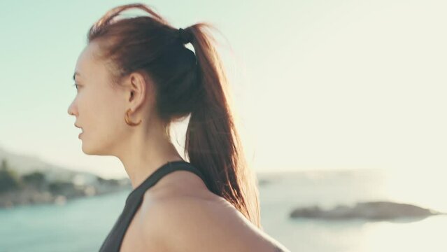Running, beach fitness and fast woman with health challenge, cardio and exercise training in lens flare. Serious athlete, sports and runner person jogging by the ocean or sea with focus mindset