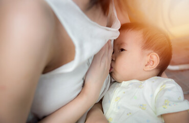 Asia baby is happy at breast-feeding time, Asian mom breast feeding her baby boy