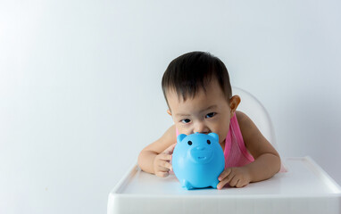 Asia baby boy saving money for future concept on white background, Happy baby with a piggy bank