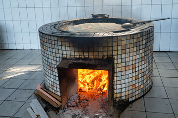 Wood burning stove with pilaf being cooked. Traditional Uzbek cuisine. Tashkent, Uzbekistan