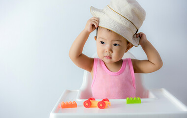 one year old baby boy wearing a hat on white background, Happy smile cute little asian