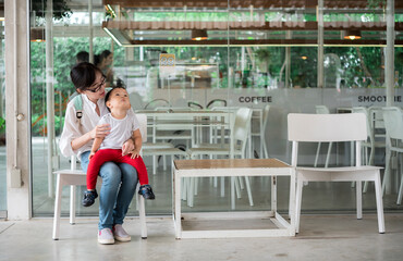 Asian The baby and mother sit in cafe