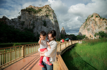 Asia mother and her baby son visit stone mountain park in thailand