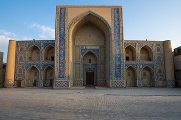 Fototapeta na wymiar Facade of the ancient Ulugbek madrasah on a sunny morning. Bukhara, Uzbekistan