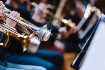 Obraz premium A musician playing a trumpet with a damaged mute in a trumpet section of an orchestra rehearsal