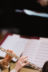 Obraz premium A musician playing the flute during in a wind band rehearsal