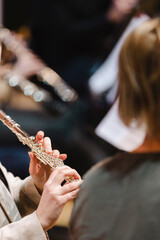 A musician playing the flute during in a wind band rehearsal
