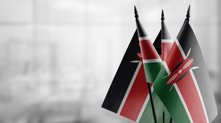 Small flags of the Kenya on an abstract blurry background