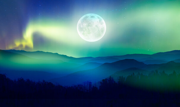 Beautiful landscape with blue misty silhouettes of mountains - Northern lights (Aurora borealis) over themountains with super full moon - 