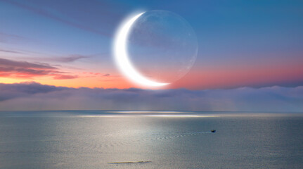 Abstract background with Crescent moon over the sea at sunset