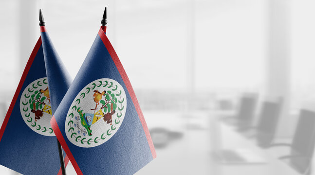 A small Belize flag on an abstract blurry background