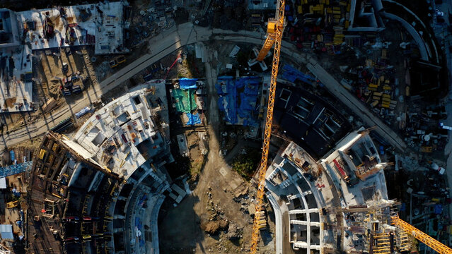 Process of building a stadium, aerial top view. Stock footage. Construction site, creation of metal structures during the construction of a stadium.