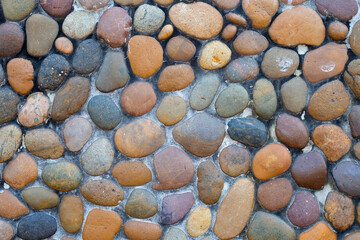 Round stones and cement wall