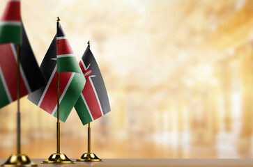 Small flags of the Kenya on an abstract blurry background
