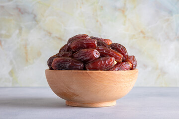 Date fruits in wooden bowl,closeup
