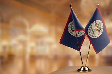 A small Belize flag on an abstract blurry background