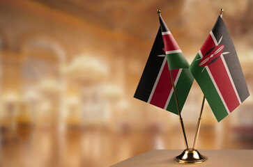 Small flags of the Kenya on an abstract blurry background