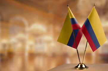 Small flags of the Colombia on an abstract blurry background