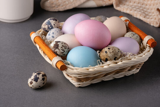Basket with easter eggs on grey background