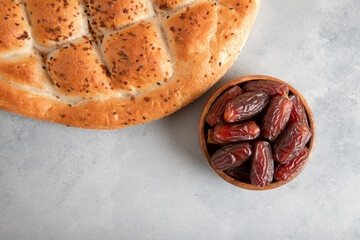  Date fruits,traditional ramadan pita on bright background,top view