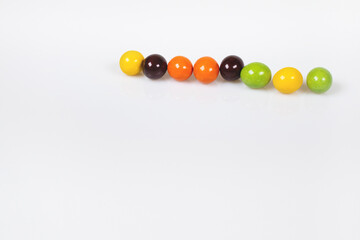 Colorful chocolate balls arranged in a row.