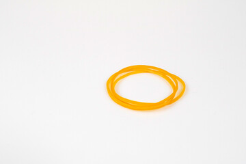 Yellow rubber bands are placed on a white background.