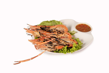 grilled shrimp on a plate served with spicy sauce