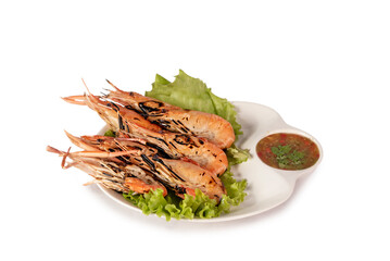 grilled shrimp on a plate served with spicy sauce