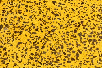 Concrete yellow floor with multicolor marble and small natural crushed stones inserted. Pebbles textured background. Decorative rough surface granite. Gravel wall material. Little rock backdrop