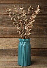 A vase with a willow on grey background. Easter, spring background with copyspace