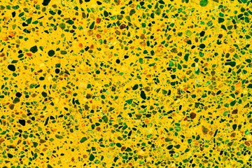 Concrete yellow floor with multicolor marble and small natural crushed stones inserted. Pebbles textured background. Decorative rough surface granite. Gravel wall material. Little rock backdrop