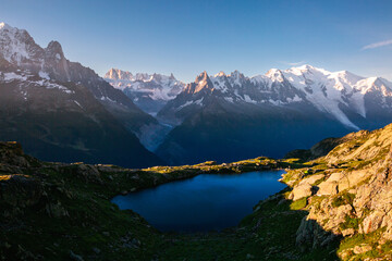 Perfect morning scene of high alpine lake Lac Blanc and Mont Blanc glacier. Graian Alps, France, Europe.