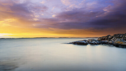 Fototapeta na wymiar Coastal scene with sunset clouds, Sweden.