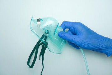 Nurse wearing medical gloves holding oxygen mask or simple mask. isolated on white