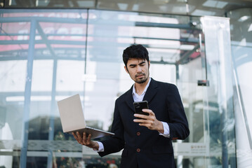 Asian businessman holding laptop.Office worker at business center