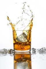 Splash of cola or whishky in a low glass isolated on a white background. selective focus. copy space