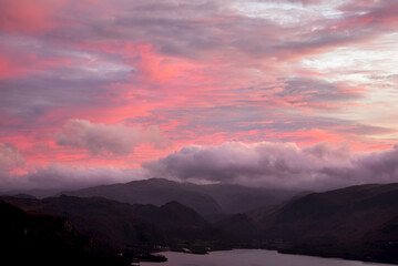 Absolutely wonderful landscape image of view across Derwentwater from Latrigg Fell in lake District during Winter beautiful colorful sunset