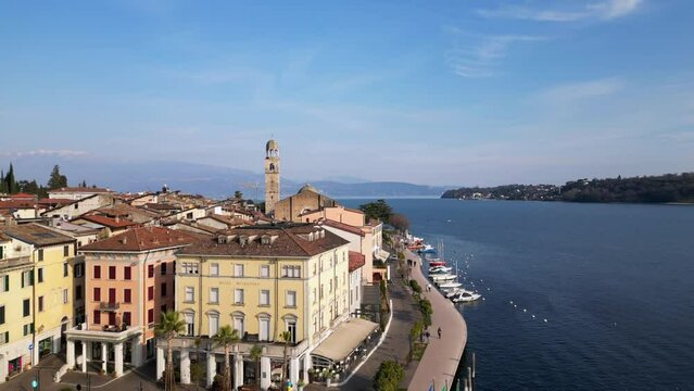 Europe, Italy, Brescia , Garda lake , Salo' drone aerial view of  village with church and lake with blue water - Italian  Republic from 1943 to 1945 during the reign of Benito Mussolini fascist 