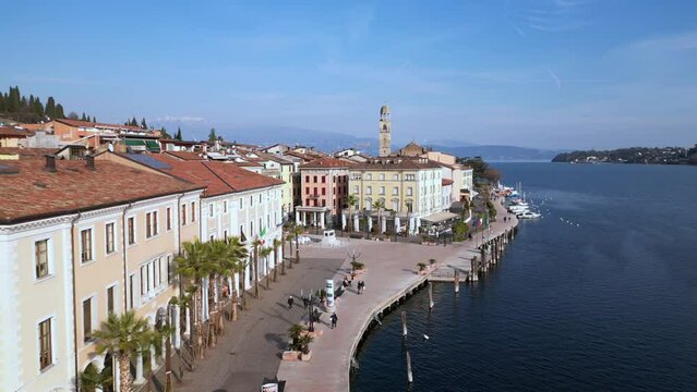 Europe, Italy, Brescia , Garda lake , Salo' drone aerial view of  village with church and lake with blue water - Italian  Republic from 1943 to 1945 during the reign of Benito Mussolini fascist 